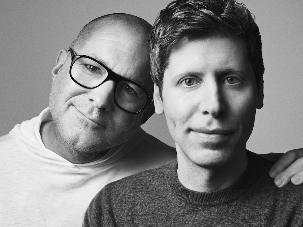 OpenAI's Sam Altman & Apple's former iPhone designer Jony Ive stand facing the camera in a partial embrace
