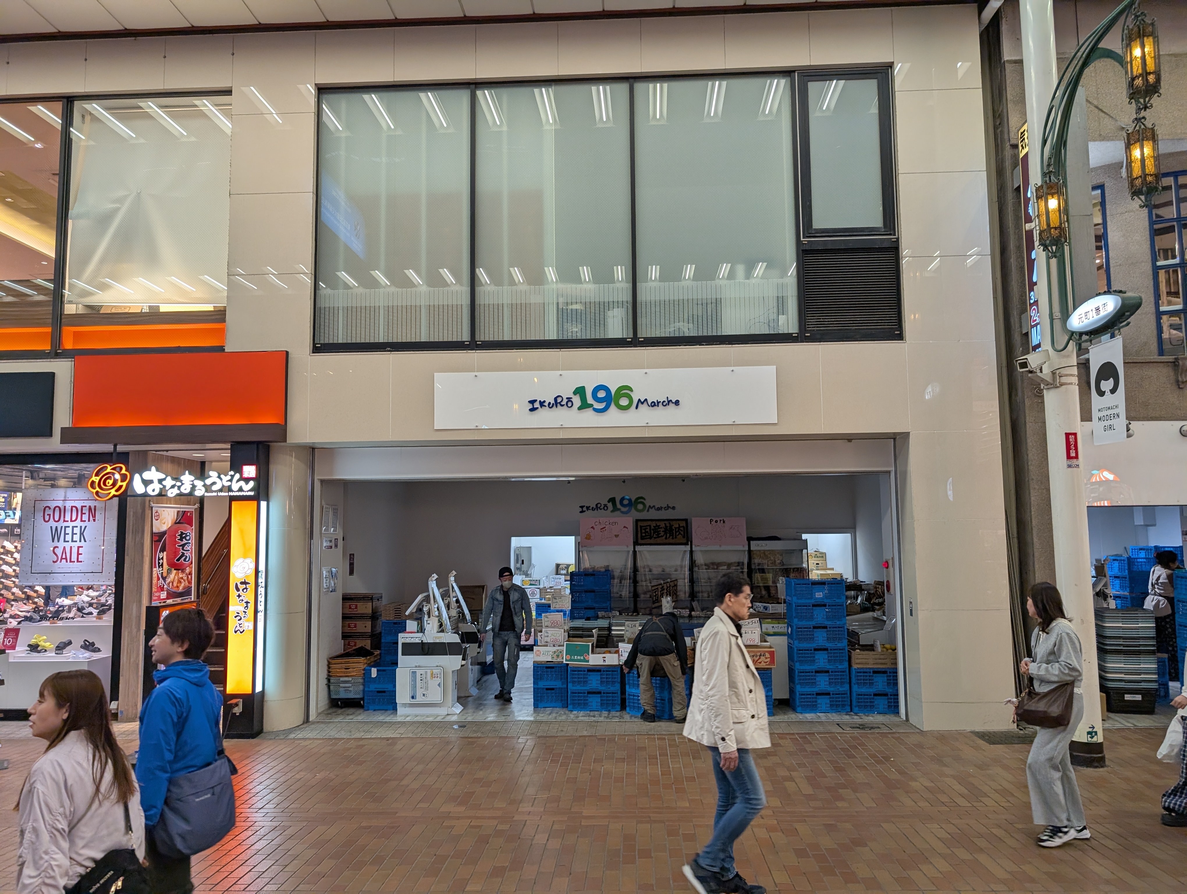 A storefront named "IkuRō 196 Marche". The 196 is written in blue and green. The store is located in a Japanese sorta shopping street thingy