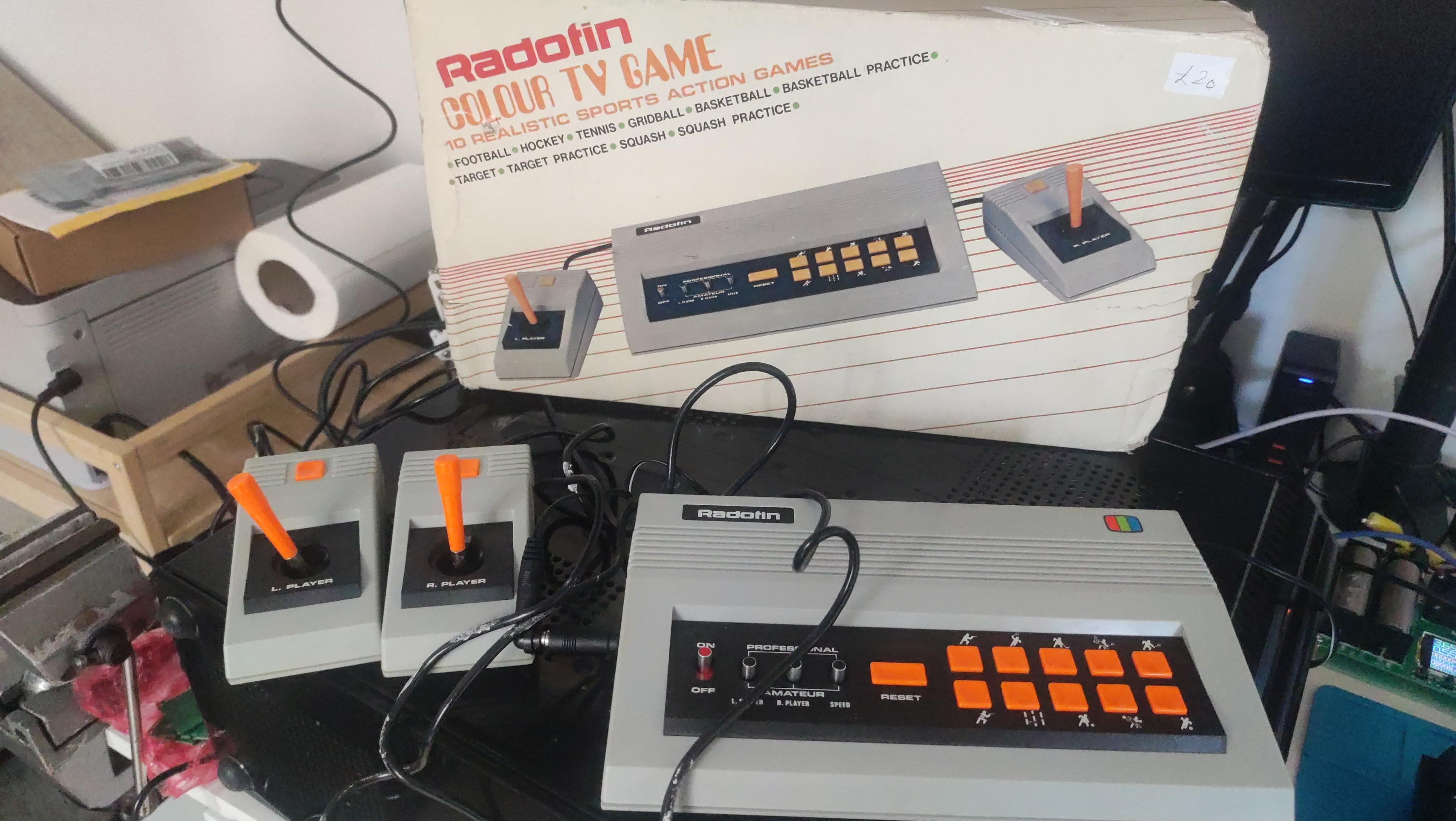 Old 1970s video game console for Pong and similar games next to its box. "Radotin Colour TV Game: 10 realistic sports action games".