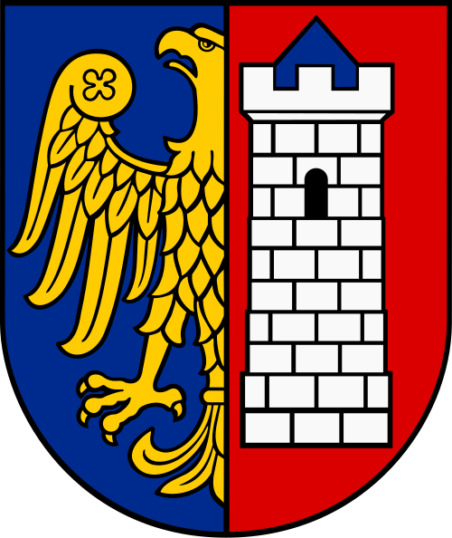 Herb jest dwudzielny w słup. Na polu heraldycznie prawym złoty półorzeł na błękitnym tle. Na polu heraldycznie lewym srebrna, ceglana i blankowana baszta z niebieskim stożkowym dachem i czarnym oknem łukowym, na czerwonym tle. 